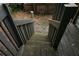 Looking down on dark wooden stairs of back deck surrounded by forest-like backyard at 936 Glynn Oaks Dr, Clarkston, GA 30021