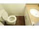 Cozy bathroom features wood look floors, tan counter tops, and white cabinetry at 936 Glynn Oaks Dr, Clarkston, GA 30021