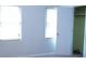 Bedroom featuring neutral walls, two windows, and access to closet at 936 Glynn Oaks Dr, Clarkston, GA 30021
