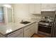 Charming kitchen features stainless appliances and granite counters at 936 Glynn Oaks Dr, Clarkston, GA 30021
