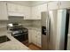 Cozy kitchen features stainless steel appliances, granite counters, and white cabinets at 936 Glynn Oaks Dr, Clarkston, GA 30021