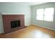 Bright living room featuring hardwood floors and a cozy brick fireplace at 936 Glynn Oaks Dr, Clarkston, GA 30021