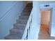 Staircase with carpeted steps and white banister at 936 Glynn Oaks Dr, Clarkston, GA 30021