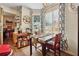 Bright breakfast nook with a marble-top table, two chairs, and a wooden cart with storage at 2080 Bankston Cir, Snellville, GA 30078