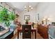Bright dining room with large window with hanging plants and a decorative chandelier at 2080 Bankston Cir, Snellville, GA 30078