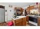 Kitchen showcasing wood cabinets, a functional center island, a black refrigerator, and classic appliances at 2080 Bankston Cir, Snellville, GA 30078