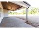 Covered back porch boasts a stained wood ceiling, ceiling fan, and a concrete floor at 269 Highway 11, Social Circle, GA 30025