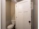 Bathroom showcasing a toilet behind an open, white door at 269 Highway 11, Social Circle, GA 30025