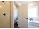 View of a bright bathroom featuring a soaking tub, shower with glass door, and neutral tile at 269 Highway 11, Social Circle, GA 30025