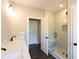 Bathroom featuring double vanity, glass shower with bench, and neutral tile at 269 Highway 11, Social Circle, GA 30025