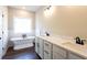 Bathroom features a soaking tub, double sink vanity with marble countertops, and dark bronze fixtures at 269 Highway 11, Social Circle, GA 30025