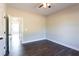 Bedroom featuring a ceiling fan, closet, and dark wood-look flooring at 269 Highway 11, Social Circle, GA 30025