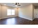 A spacious bedroom features hardwood floors, a window for natural light, and a ceiling fan at 269 Highway 11, Social Circle, GA 30025