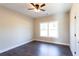 Bedroom features a ceiling fan, large window, and dark wood-look flooring at 269 Highway 11, Social Circle, GA 30025