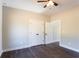 Bedroom features a ceiling fan, a double door closet, and dark wood-look flooring at 269 Highway 11, Social Circle, GA 30025