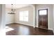 Bright entryway features hardwood flooring and a stylish chandelier at 269 Highway 11, Social Circle, GA 30025