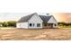 A charming one-story new construction home featuring light siding, a dark roof and an attached garage at 269 Highway 11, Social Circle, GA 30025