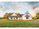 Charming two-story home featuring a covered porch and a well-manicured lawn at 269 Highway 11, Social Circle, GA 30025
