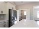 A stainless steel refrigerator is next to a walk-in pantry that features custom-built shelving at 269 Highway 11, Social Circle, GA 30025