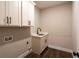 Laundry room featuring modern cabinetry, a sink, and hookups for a washer and dryer at 269 Highway 11, Social Circle, GA 30025