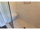 A close-up of a glass shower with bench and neutral, textured tiles at 269 Highway 11, Social Circle, GA 30025