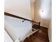 Stairway with dark hardwood steps and railing against neutral walls at 269 Highway 11, Social Circle, GA 30025
