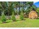 Well-maintained backyard with a storage shed and mature trees, offering privacy at 4365 Wicklow Ct, Suwanee, GA 30024