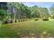 Expansive backyard with mature trees, a pergola and a fire pit, offering ample space for recreation at 4365 Wicklow Ct, Suwanee, GA 30024