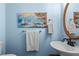 Bright bathroom featuring a decorative mirror, sink, and seascape wall art at 4365 Wicklow Ct, Suwanee, GA 30024