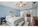 Bedroom featuring wood-look floors, trey ceiling and a queen size bed at 4365 Wicklow Ct, Suwanee, GA 30024