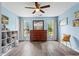 Bedroom featuring wood-look floors, a wood dresser and natural light from the windows at 4365 Wicklow Ct, Suwanee, GA 30024