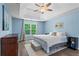 Bright bedroom features a trey ceiling, neutral colors and wood-look floors at 4365 Wicklow Ct, Suwanee, GA 30024