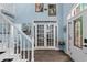 Bright foyer with elegant glass doors, and staircase leading to the upper level of the home at 4365 Wicklow Ct, Suwanee, GA 30024