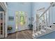 Bright foyer with a grand entrance, staircase to the upper level, and view of the open floor plan at 4365 Wicklow Ct, Suwanee, GA 30024