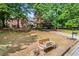 Well-maintained front yard with mature trees, landscaped garden beds, and a brick facade house at 4365 Wicklow Ct, Suwanee, GA 30024
