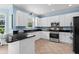 Modern kitchen has stainless steel appliances, white cabinets and dark granite countertops at 4365 Wicklow Ct, Suwanee, GA 30024
