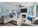Spacious living room with hardwood floors, comfortable seating, fireplace, and ample natural light at 4365 Wicklow Ct, Suwanee, GA 30024