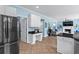 Open layout showcases modern kitchen leading into a cozy living room with fireplace, TV and plenty of natural light at 4365 Wicklow Ct, Suwanee, GA 30024