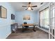 Bright office features a ceiling fan, wood-look floors, and a rustic wooden desk at 4365 Wicklow Ct, Suwanee, GA 30024