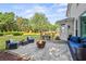 Outdoor patio with fire pit, cozy seating, and a lush green lawn for relaxing and entertaining at 4365 Wicklow Ct, Suwanee, GA 30024