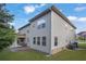Back exterior of home shows neutral siding, a covered patio, and well maintained lawn at 4511 Bridgeway Rd, Atlanta, GA 30331
