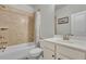 Tiled bathroom with shower-tub combination and white vanity at 4511 Bridgeway Rd, Atlanta, GA 30331