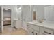 Dual vanity bathroom with white cabinets, tile floors, and modern fixtures at 4511 Bridgeway Rd, Atlanta, GA 30331