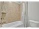 Tiled bathroom featuring a shower-tub combination with neutral walls at 4511 Bridgeway Rd, Atlanta, GA 30331