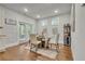 Bright dining area with hardwood floors, glass table, and walkout to a backyard at 4511 Bridgeway Rd, Atlanta, GA 30331