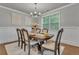 Formal dining room with elegant wainscoting, wood floors, and modern chandelier at 4511 Bridgeway Rd, Atlanta, GA 30331