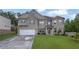 Beautiful two-story brick home featuring a two-car garage and lush green lawn at 4511 Bridgeway Rd, Atlanta, GA 30331