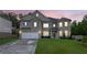Beautiful two-story brick home featuring a two-car garage and lush green lawn at twilight at 4511 Bridgeway Rd, Atlanta, GA 30331