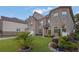 Well-manicured front yard landscaping with palm trees accents a two-story brick home at 4511 Bridgeway Rd, Atlanta, GA 30331