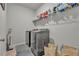 A laundry room featuring modern washer and dryer, with overhead shelf at 4511 Bridgeway Rd, Atlanta, GA 30331